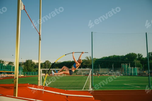 Preview: Female high jumper training at the stadium in sunny day