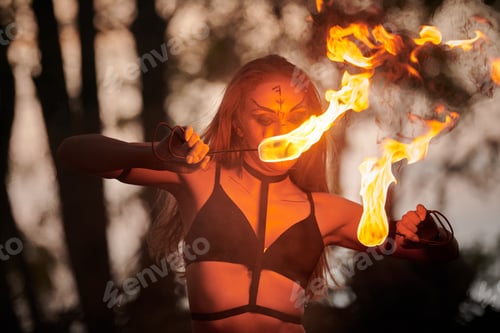 Preview: Girl fire dancing performance at outdoor art festival, smooth movements of female artist