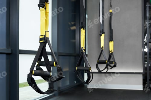 Preview: Black and yellow TRX in gym.
