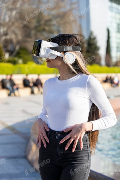 Preview: Street photo. young lady wears virtual reality glasses