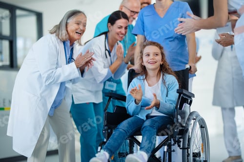 Preview: Medical staff clapping to little girl patient who recovered from serious illness.