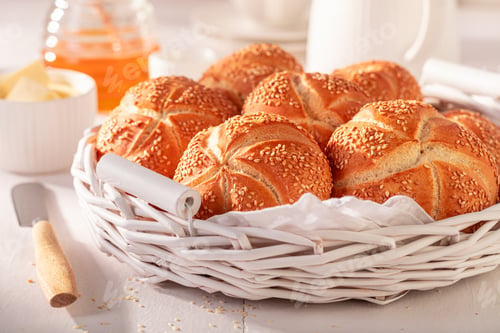 Preview: Tasty Kaiser buns with sesame in white basket.