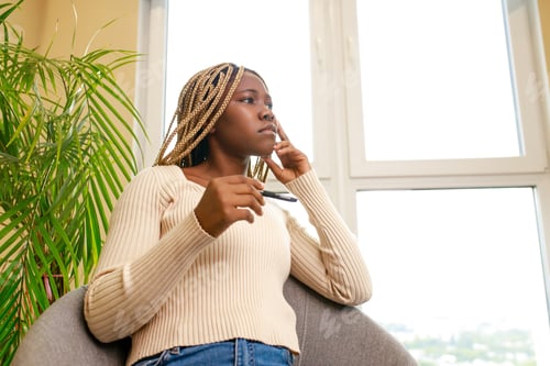 Preview: african american woman having pleasant conversation by mobile with friend