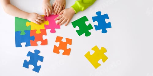 Preview: The pieces of multicolored puzzles are put together by children