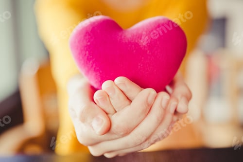 Preview: A woman hands is holding a pink heart, love valentine concept