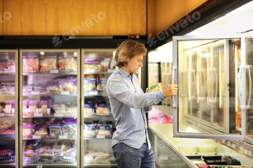 Preview: Man Choosing Frozen Food From A Supermarket Freezer