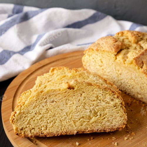 Preview: Homemade Irish Soda Bread on a black background, side view. Close-up.