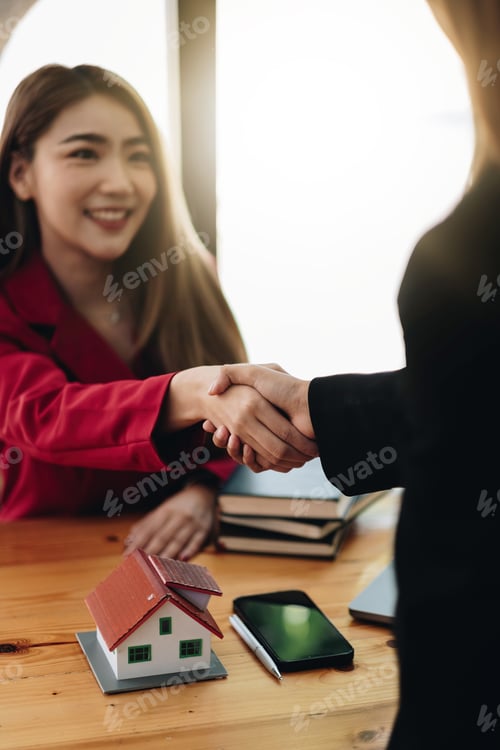 Preview: Estate agent and customer shaking hands after finished contract after about home insurance and