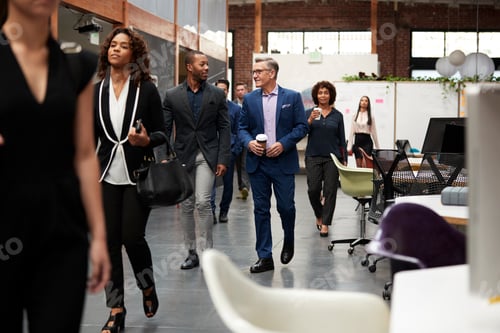 Preview: Businesspeople Arriving For Work In Busy Modern Open Plan Office