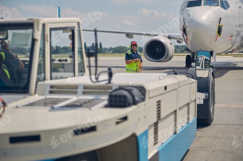 Preview: Ground crew preparing for towing an airplane