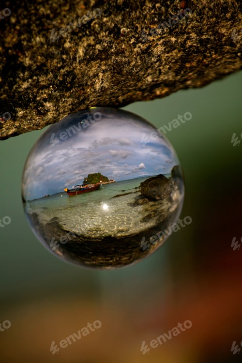 Preview: Selective focused shot of the beach on Koh Lipe reflected in a glass ball with a blurred background