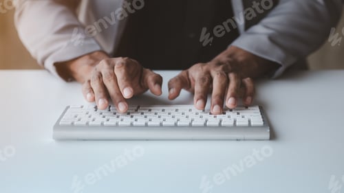 Preview: Person typing on a computer keyboard, businessman is working in a startup company's office.