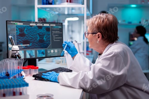 Preview: Biotechnologist senior scientist researching with test tube