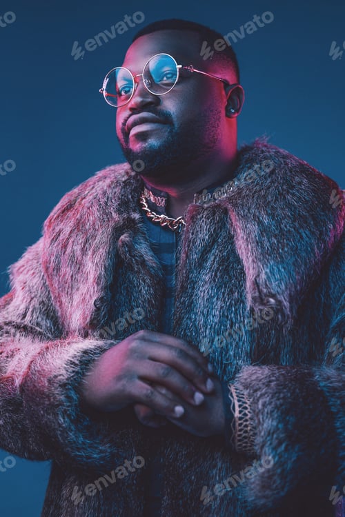 Preview: Confident fashion black man with fur coat and glasses