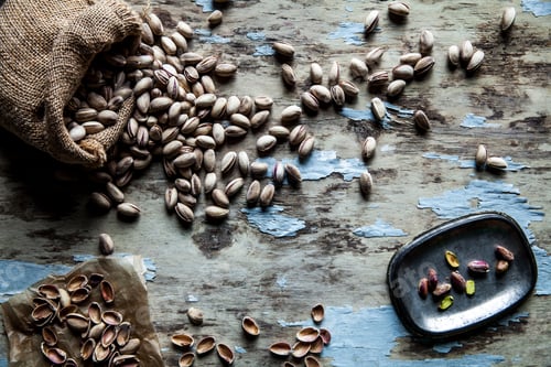 Preview: Roasted pistachios on natural wooden table background
