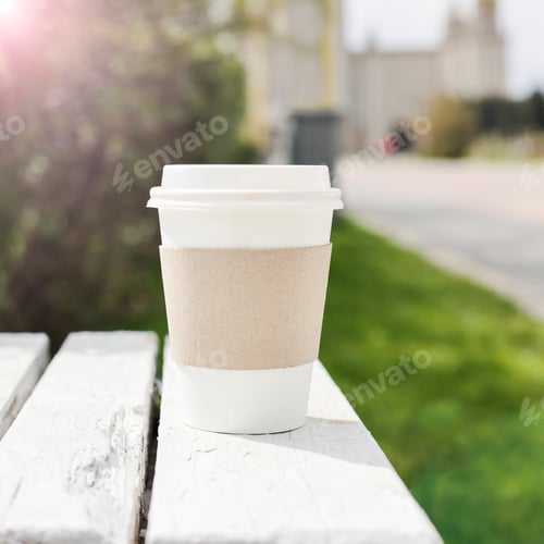 Preview: Mockup of take away paper cup for coffee or tea on bench outside in sunny day. copy space.