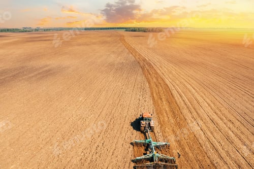 Preview: Elevated View Tractor Plowing Field In Spring Season. Beginning Of Agricultural Spring Season