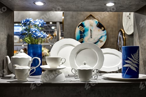 Preview: a showcase with the laying of porcelain dishes. Beautiful merchandising, dishes for restaurants and
