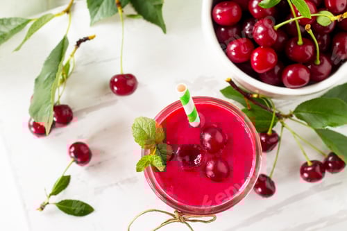 Preview: Cherry milkshake or smoothie on a white wooden background.
