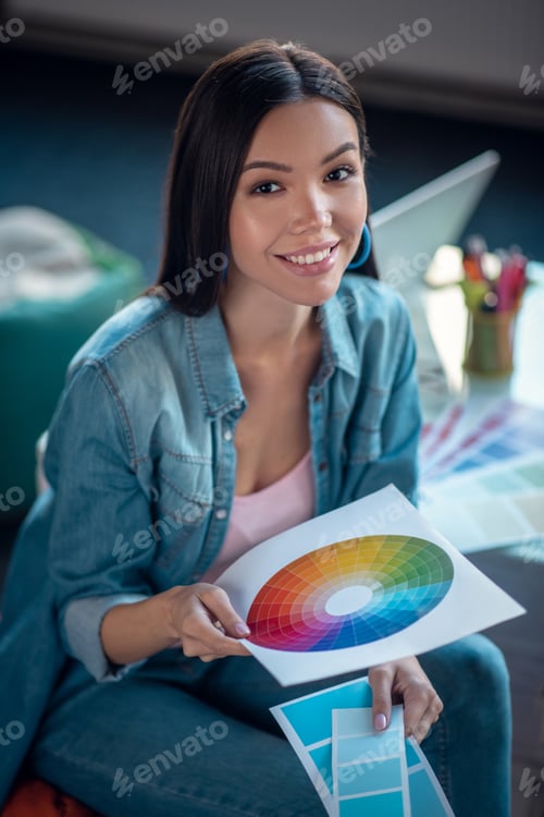 Preview: Joyful nice woman holding a colour scheme