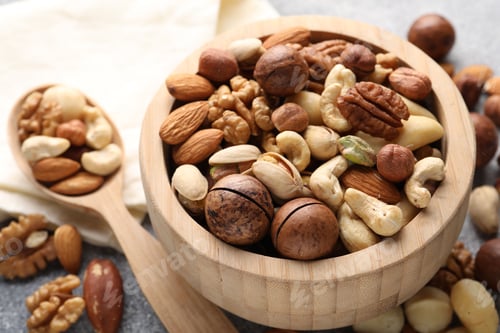 Preview: Mix of different nuts on grey table, closeup