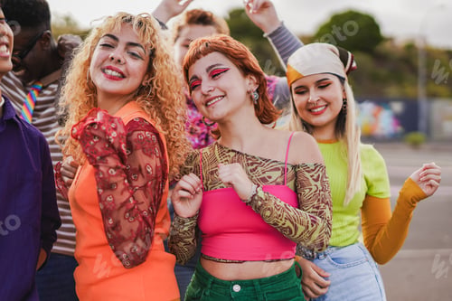 Preview: Happy multiracial people dancing at music concert outdoor during summer time