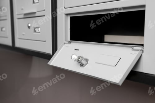 Preview: Open empty metal mailbox with keyhole indoors