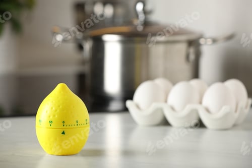 Preview: Kitchen timer in shape of lemon on white table indoors. Space for text