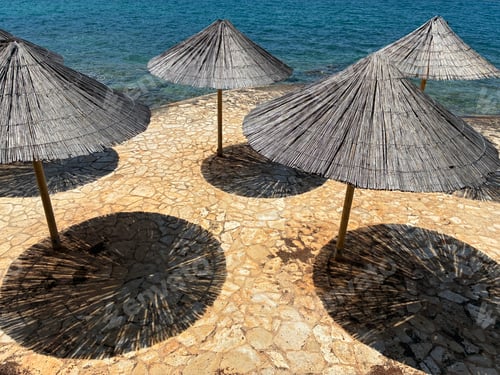 Preview: parasoles from above near the sea