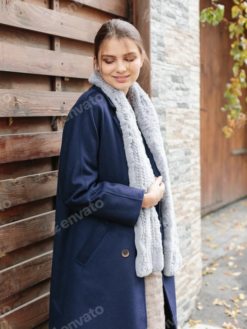 Preview: Happy business woman walking at beautiful autumn city street wearing colorful scarf and warm coat