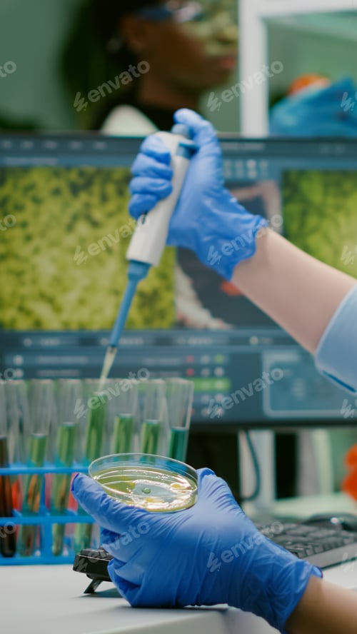 Preview: Scientist woman taking genetic solution from test tube with micropipette