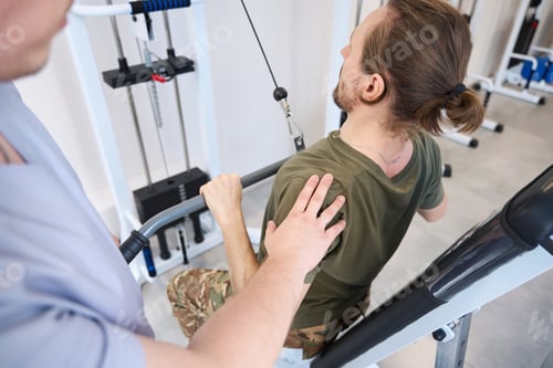 Preview: Military man is engaged in simulator medical center under guidance instructor