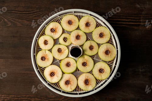 Preview: Flat layout of circle tray of fruit dryer with slices of fresh apples on table