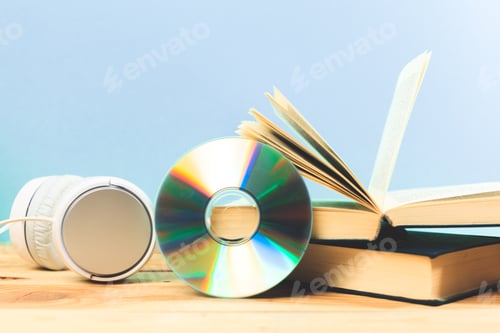 Preview: Books on the table with headphones put on them