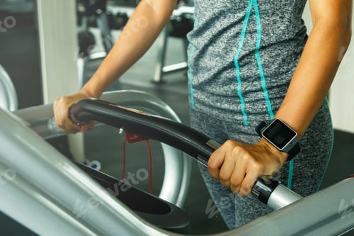 Preview: Closeup of female hand with smart watches in the gym