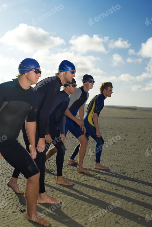 Preview: Swimmers standing in row on beach