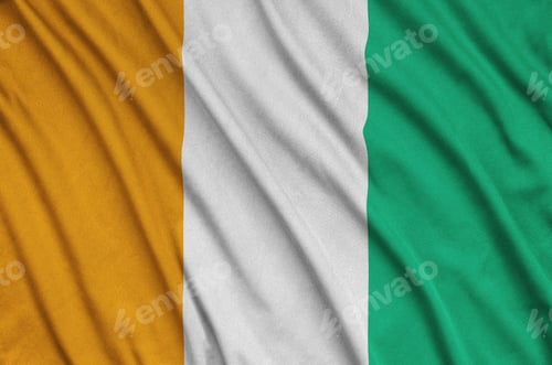 Preview: Ivory Coast flag is depicted on a sports cloth fabric with many folds. Sport team waving banner