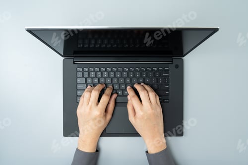 Preview: Overhead view of business man busy using laptop