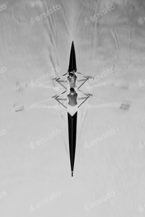 Preview: Overhead view of a double scull pair rowing together, two people.