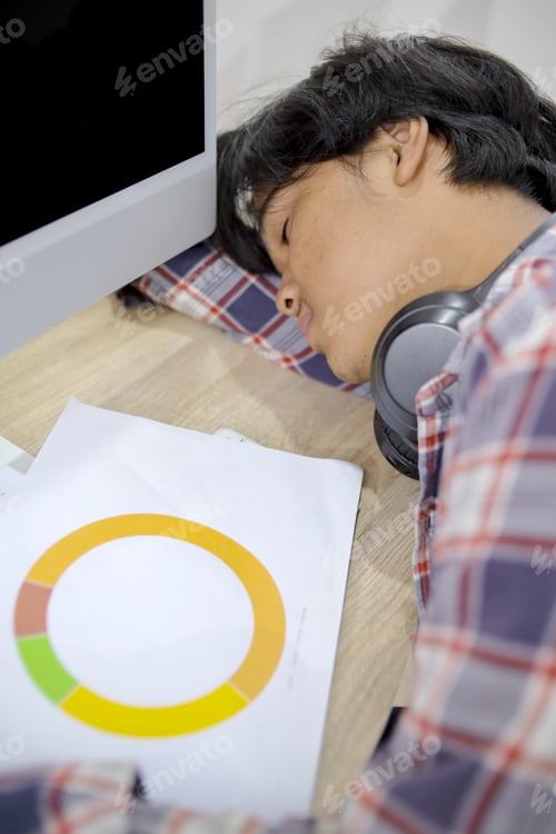 Preview: Tired Man Napping at Desk in Workplace