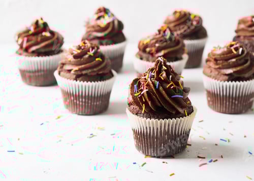 Preview: Delicious Chocolate Cupcakes with Sprinkles on White Table