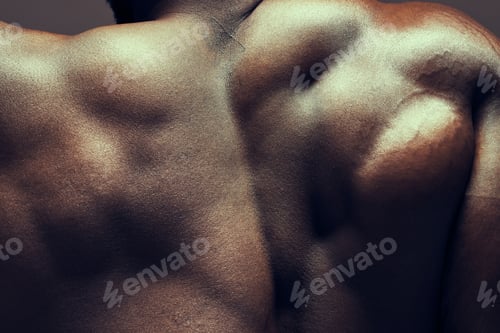 Preview: Shot of a muscular man posing against a studio background