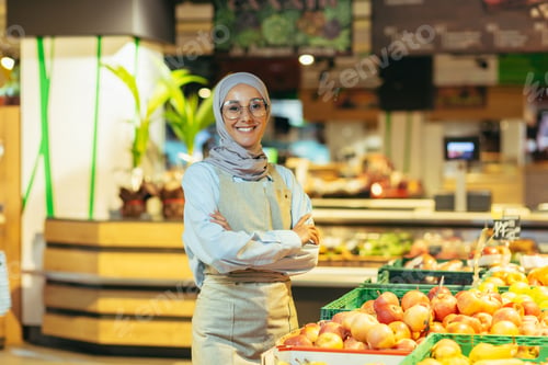 Preview: Portrait of a beautiful young Muslim woman in a hijab, who works in a supermarket