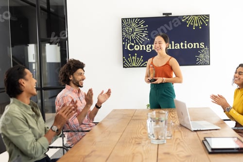 Preview: Celebrating colleague's achievement, business team applauding during office meeting