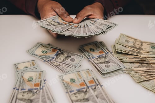 Preview: African American man sounding a pile of one hundred dollar bills, business, savings, finance