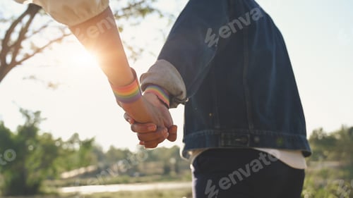 Preview: Cropped shot of LGBT while holding hand at park. LGBT happiness concept.