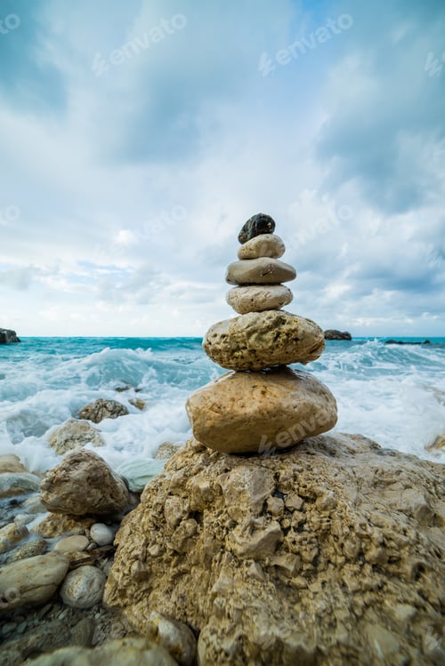 Preview: Sea dramatic landscape, harmony environment and zen stones tower silhouette. Meditation photography