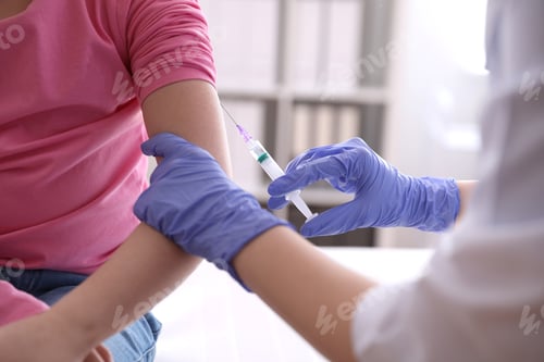 Preview: Little girl receiving chickenpox vaccination in clinic, closeup. Varicella virus prevention