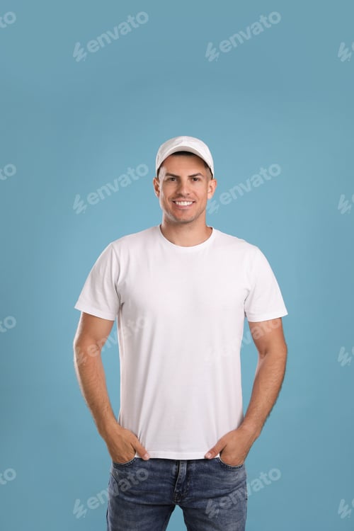 Preview: Smiling Man Poses in White T-Shirt and Hat