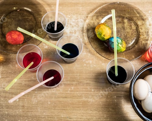 Preview: Easter eggs and colored liquid paints on the table